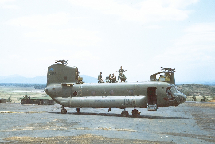 A crewed of young mechanics and flight crews prepare 67-18518 for the sling load air transport.