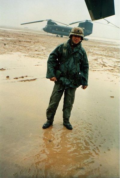 SPC Troy Stokes, Crew Chief on 85-24335, takes a shower on a rainy day in Iraq.