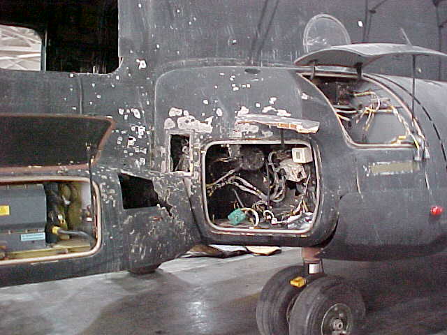 RPG damage to electrical pod, left side near cockpit.