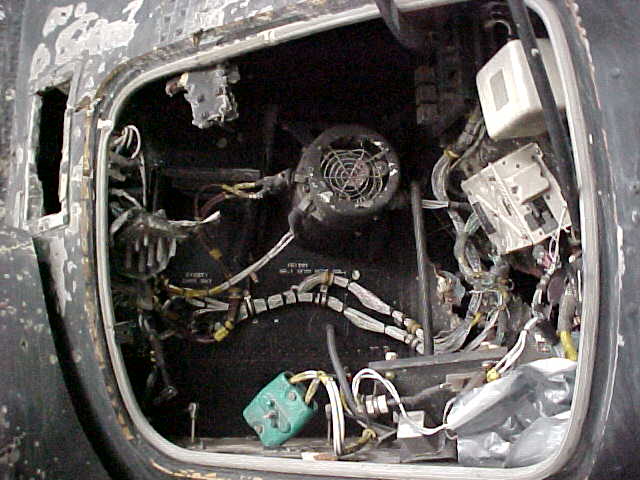 RPG damage to electrical pod, left side near cockpit.