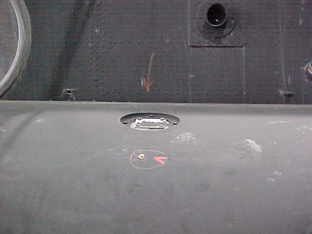 Bullet hole in fuel tank, left side.