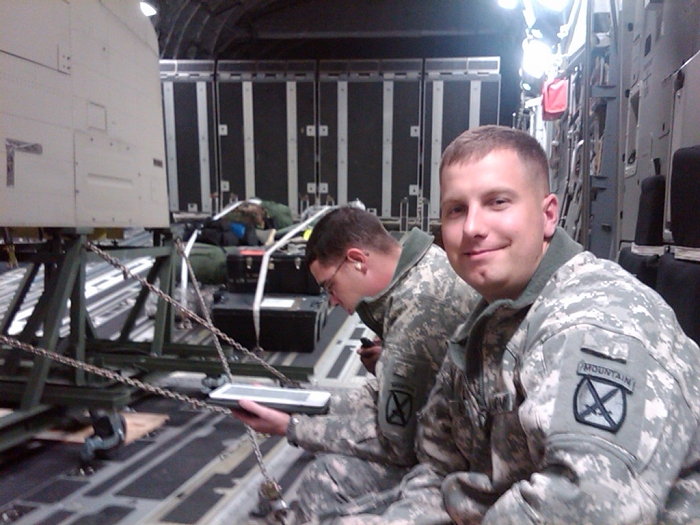 SGT Christopher J. Utter, Flight Engineer of CH-47F Chinook helicopter 09-08060, and his Crew Chief, SGT Matthew Bos, await takeoff from Wheeler-Sack Army Airfield aboard a C-17 aircraft for deployment to Afghanistan.