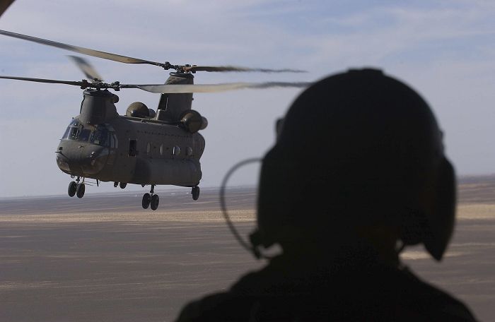 With a sister ship in tow, an Australian CH-47D scours the barren landscape in search of the bad guys.