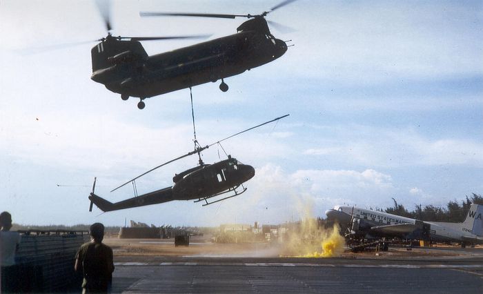 As seen in this 1967 photograph, a 178th ASHC "Boxcar" Chinook recovers a downed UH-1 Huey and returns it to Chu Lai, RVN.