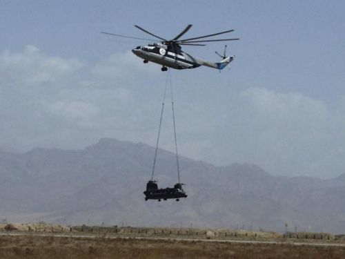 An MH-47E being air lifted by the Russian built MI-26 helicopter.