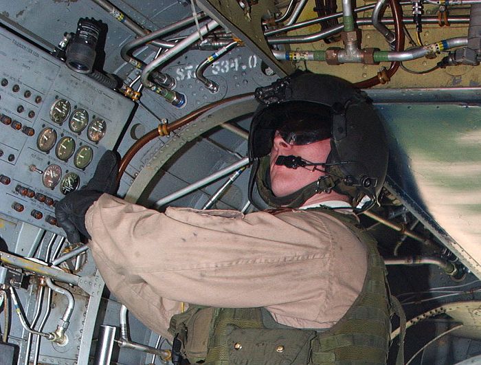 A crew chief conducts an in-flight check in a CH-47D Chinook helicopter on a flight from Jalalabad in Afghanistan. The soldier is assigned to C Company - "Flippers", 159th Aviation Regiment, home-based at Fort Bragg, North Carolina.