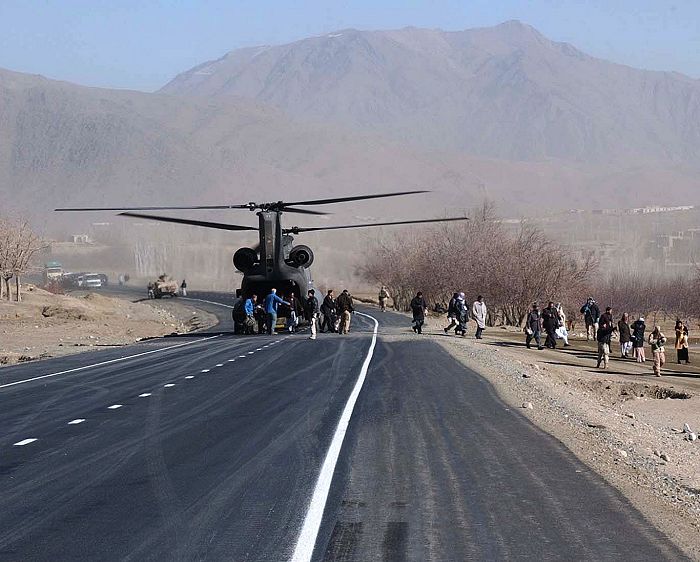 A soldier pulls security as a CH-47D Chinook helicopter lands. The helicopter is transporting detainees apprehended during a raid on a suspected terrorist camp in southwest Iraq. The soldier is assigned to the 101st Pathfinder Company, 101st Airborne Division.