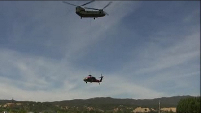 A UH-60 Black Hawk helicopter is airlifted by a California Army National Guard CH-47D Chinook helicopter from a field in Scotts Valley, outside of Lakeport, California, on Thursday, 13 September 2012.