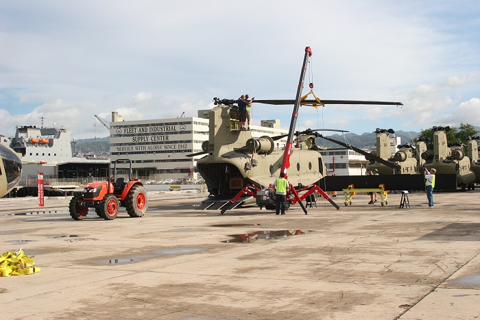 19 November 2010: CH-47F Chinook helicopter 09-08064 undergoing reassembly on the dock at Pearl Harbor, Hawaii. In the background is the USNS Mendonca.