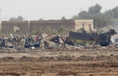 U.S. soldiers carry a stretcher to the scene after a U.S. Chinook helicopter, right, believed to be carrying dozens of soldiers to leaves abroad was struck by a missile and crashed west of Baghdad, near Fallujah on Sunday, 2 November 2003, killing 15 soldiers and wounding 26 others, the U.S. command and witnesses reported.